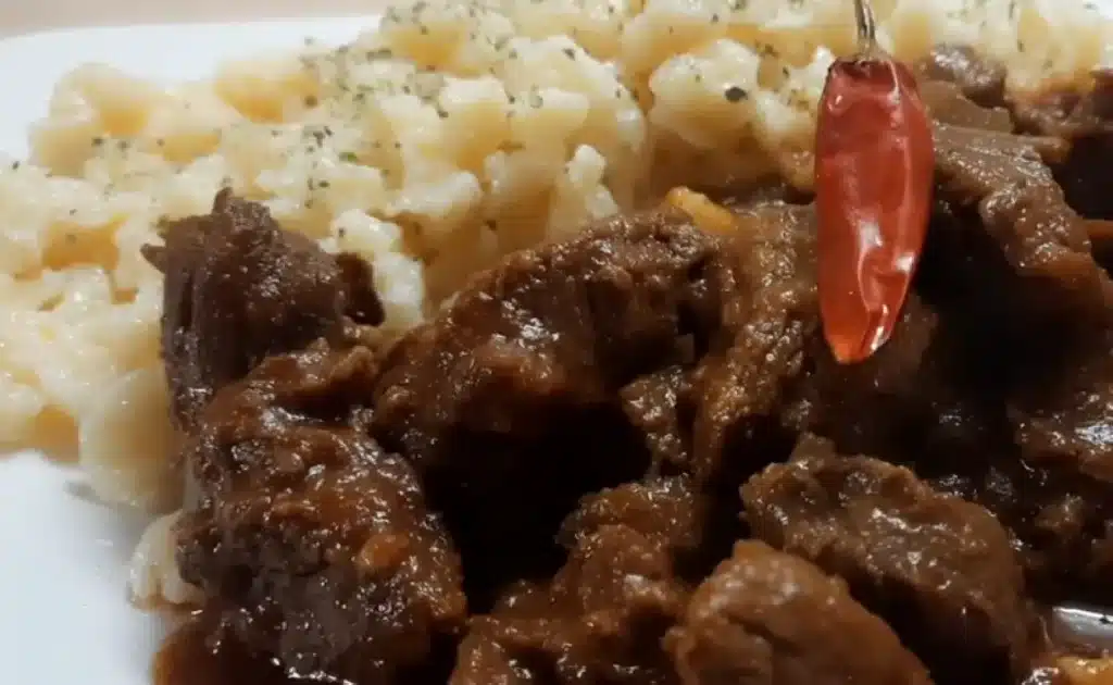 Layered game stew in a cauldron